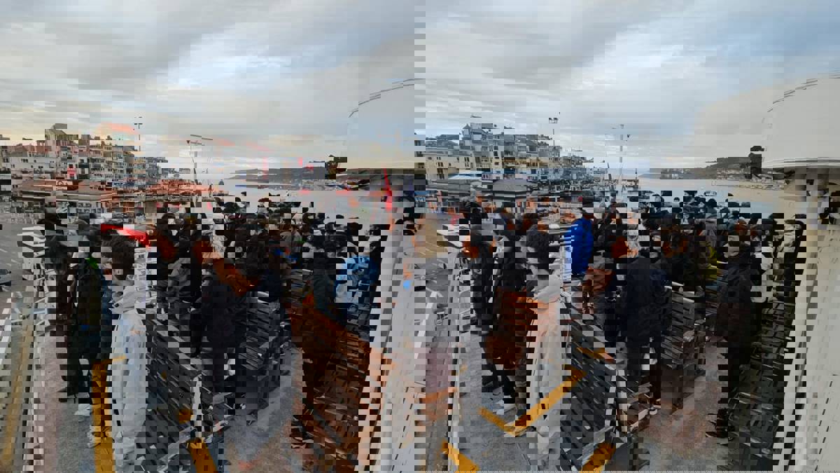 People observing a minute of silence on a ferry