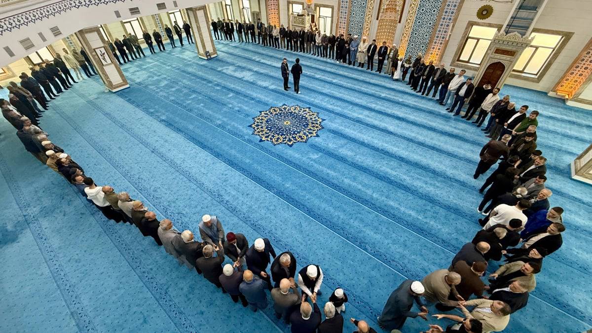 People celebrating each other's feast in a mosque after prayers in Karabük, northern Turkey
