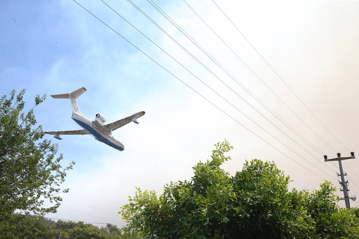 A firefighting plane flying over the area